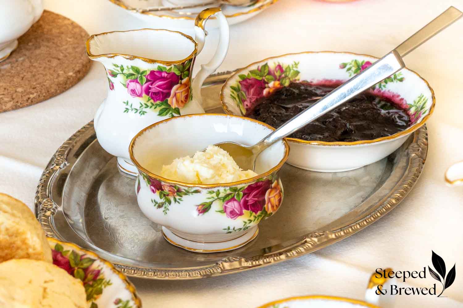 Clotted cream, jam, and tea accessories for a cream tea