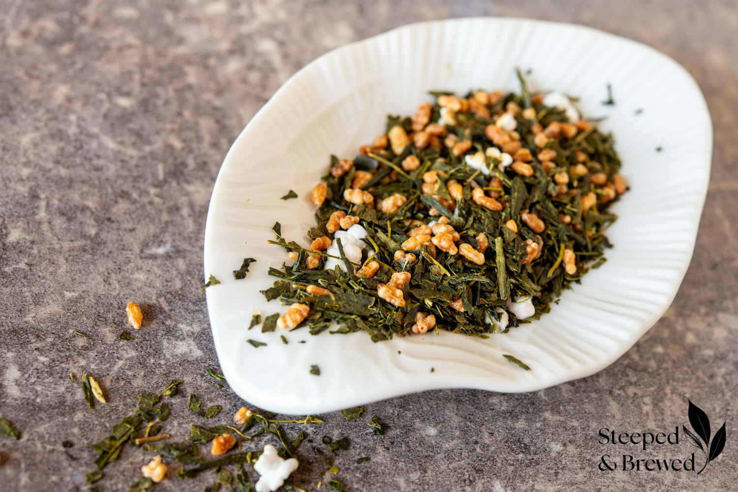 Genmaicha tea leaves on a white dish